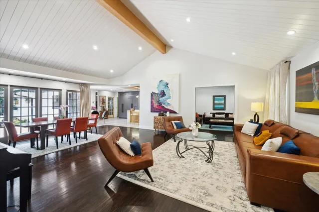 a living room with furniture a rug and a flat screen tv