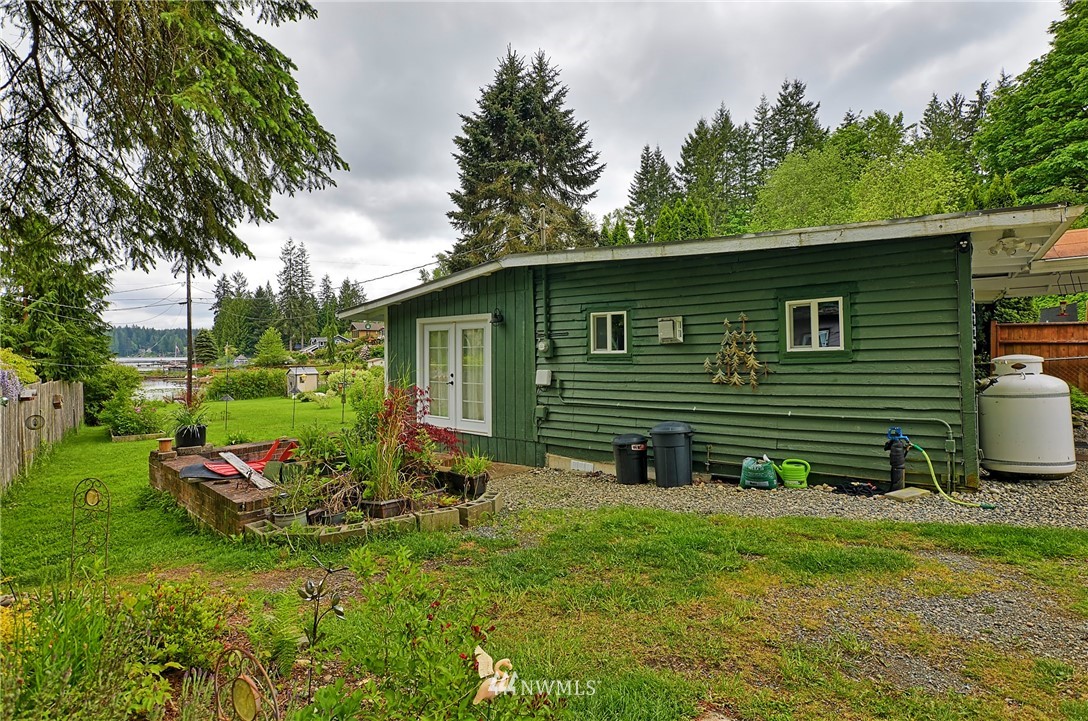 18812 Lerch Road Snohomish, WA 98290 - Photo 31 of 35 a backyard of a house with table and chairs potted plants and large tree