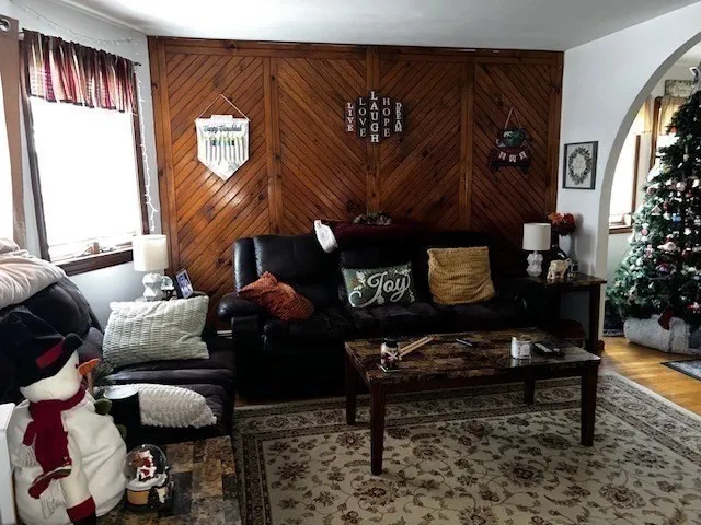 a living room with furniture and a potted plant