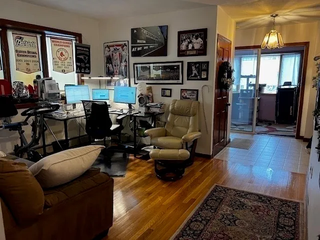 a living room with furniture fireplace and a window