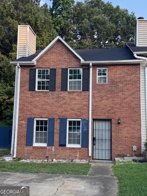 990 Hickory Bend Road Atlanta, GA 30349 - Photo 1 of 1 a front view of a house with a yard and garage