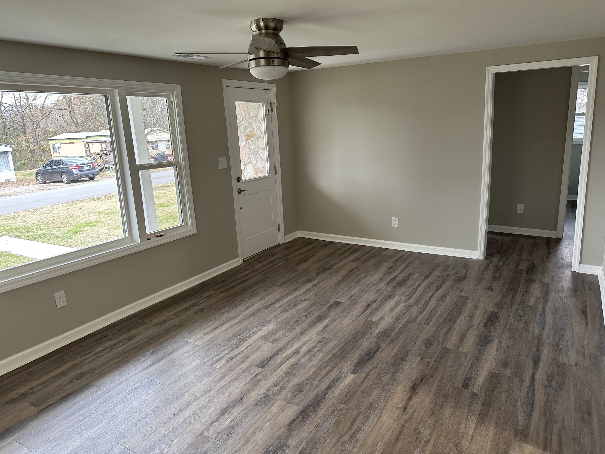 404 Horton Street Decherd, TN 37324 - Photo 4 of 12 a view of an empty room with wooden floor and a window