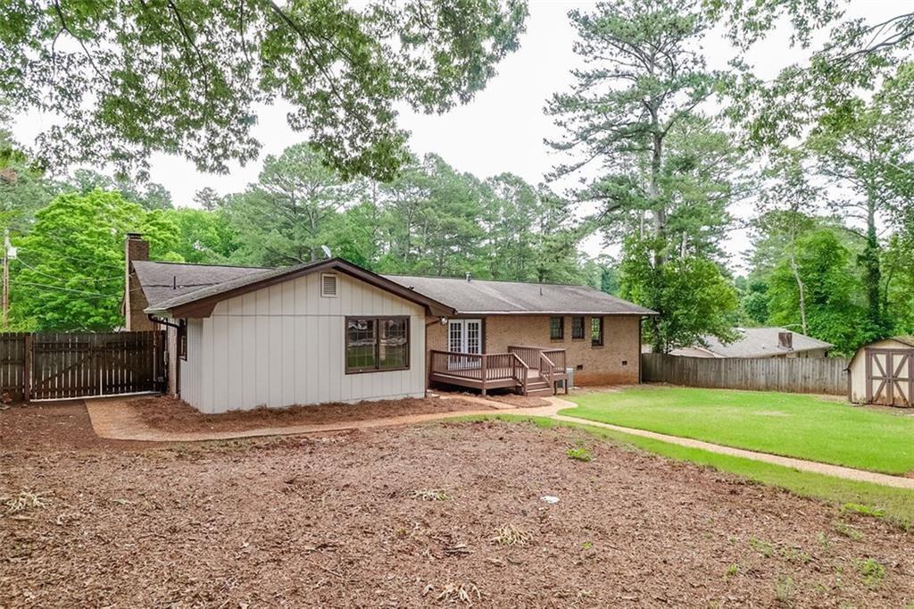 1291 Stephens Street Southwest Lilburn, GA 30047 - Photo 6 of 22 a view of a house with a yard