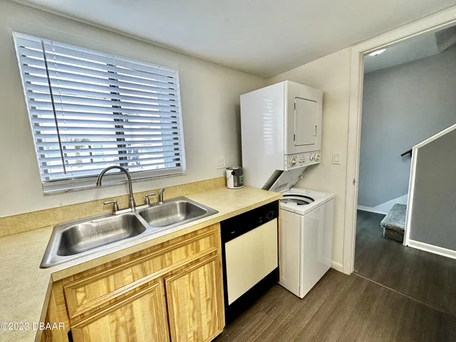 a kitchen with stainless steel appliances granite countertop a sink and a window
