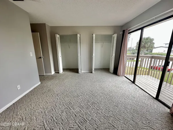 an empty room with large windows