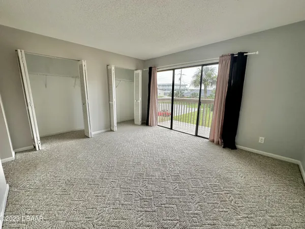 a view of an empty room with glass door