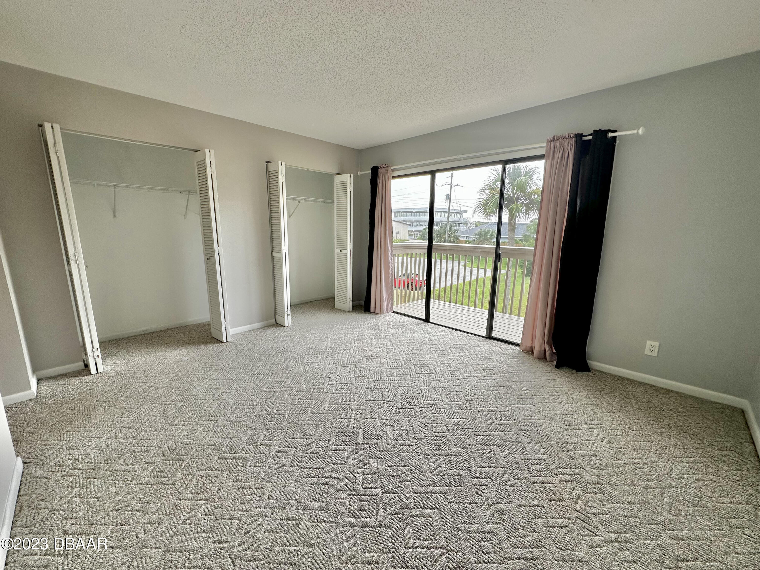 4790 South Atlantic Avenue, Unit D403 Ponce Inlet, FL 32127 - Photo 15 of 27 a view of an empty room with glass door
