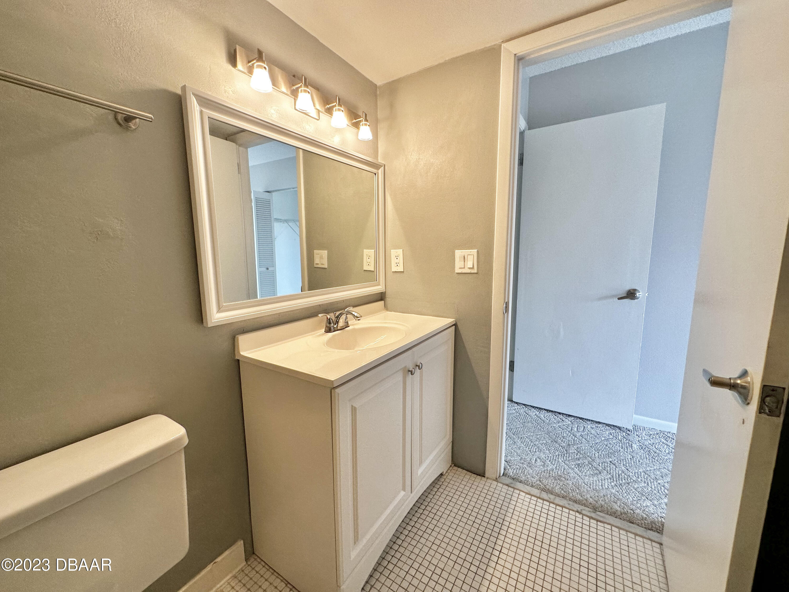 4790 South Atlantic Avenue, Unit D403 Ponce Inlet, FL 32127 - Photo 19 of 27 a bathroom with a sink a toilet a mirror and shower