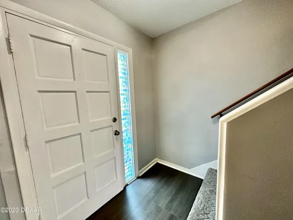 an empty room with wooden floor and closet