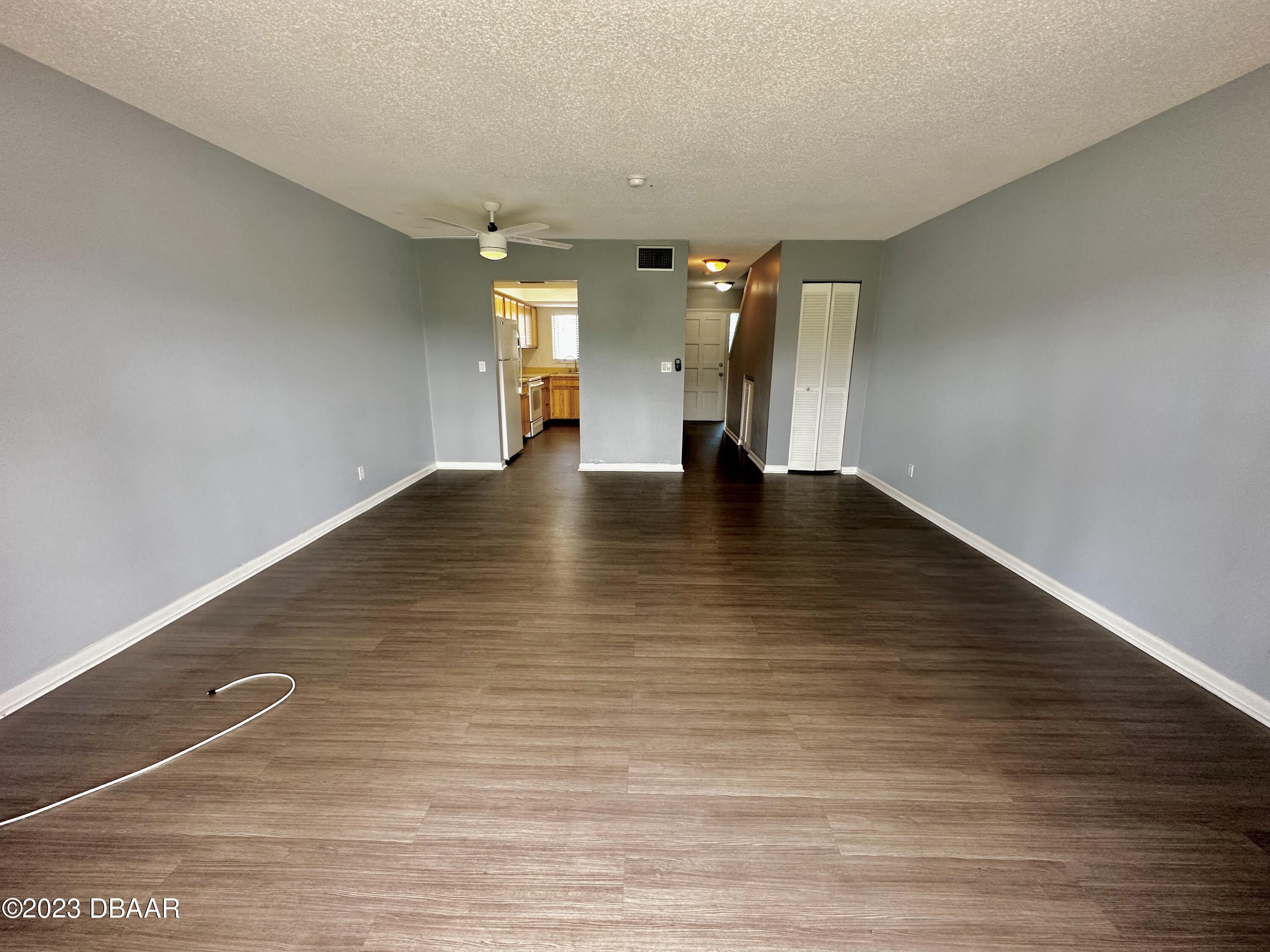 4790 South Atlantic Avenue, Unit D403 Ponce Inlet, FL 32127 - Photo 6 of 27 a view of an empty room with wooden floor