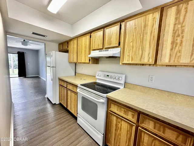 a kitchen with a sink a stove and cabinets