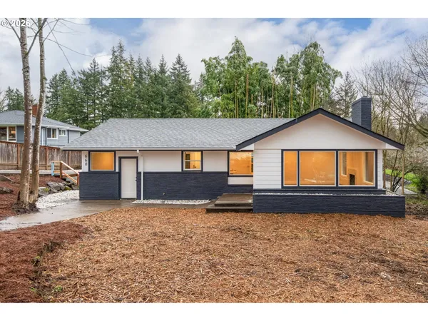 a house with lots of trees in the background