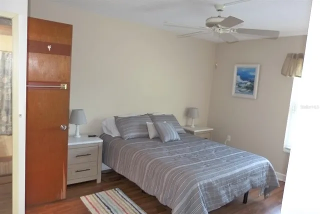 a bedroom with a large bed and a chandelier