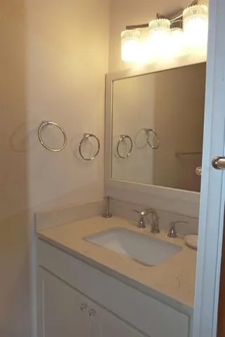 a bathroom with a sink and mirror