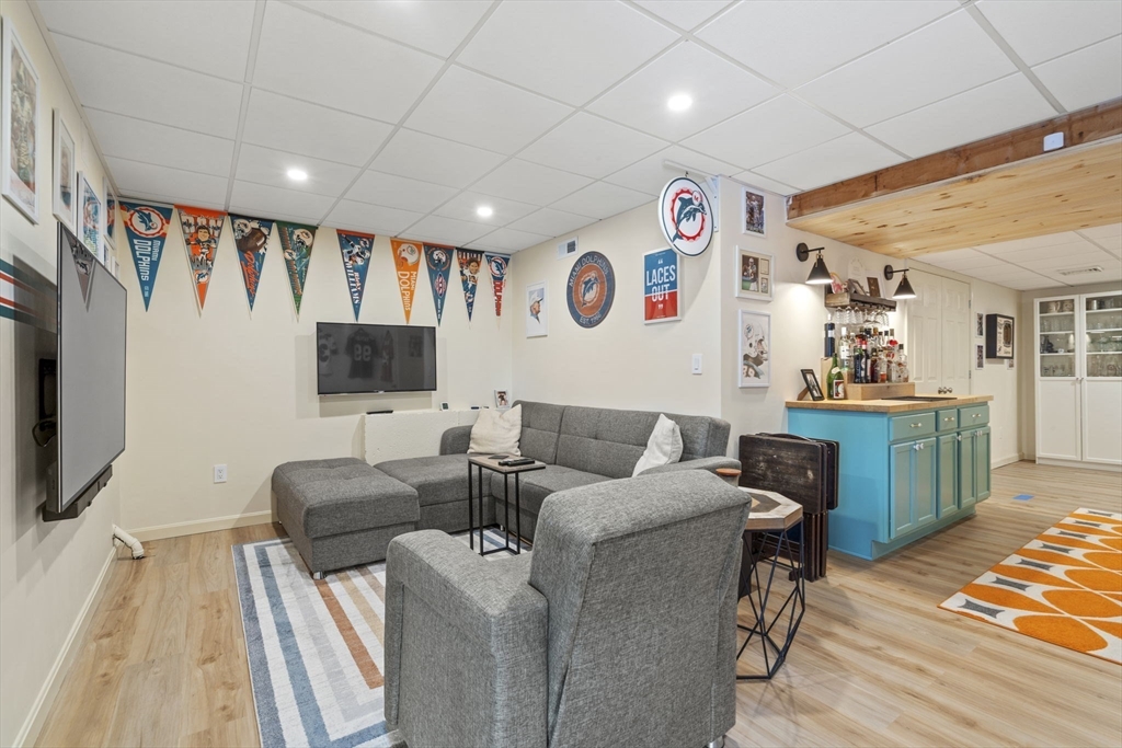 4 Apple Ridge Road, Unit 6 Maynard, MA 01754 - Photo 23 of 40 a living room with furniture and a flat screen tv