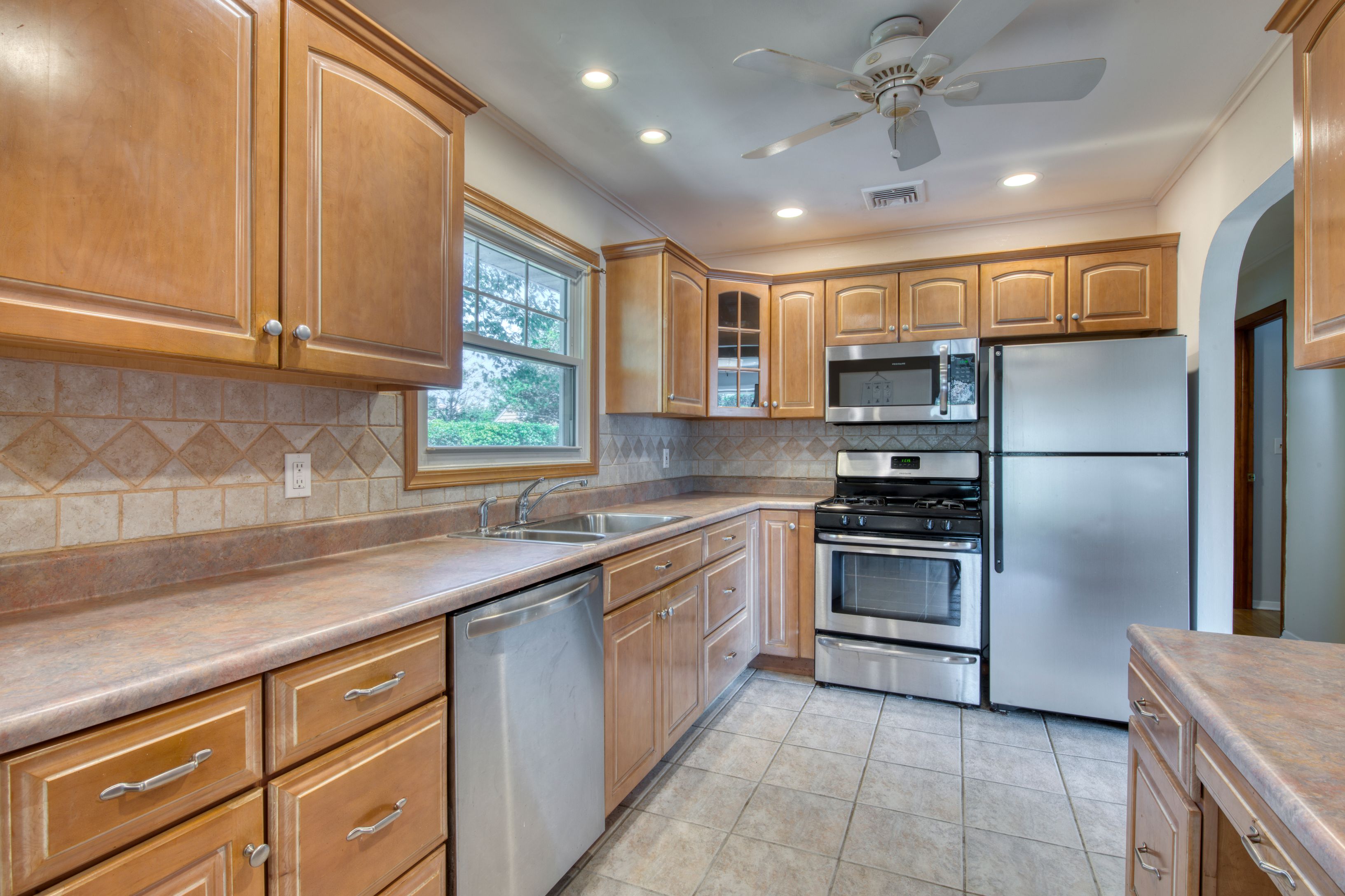 35 Ridge Drive Sag Harbor, NY 11963 - Photo 7 of 14 a kitchen with kitchen island granite countertop a sink stainless steel appliances and cabinets