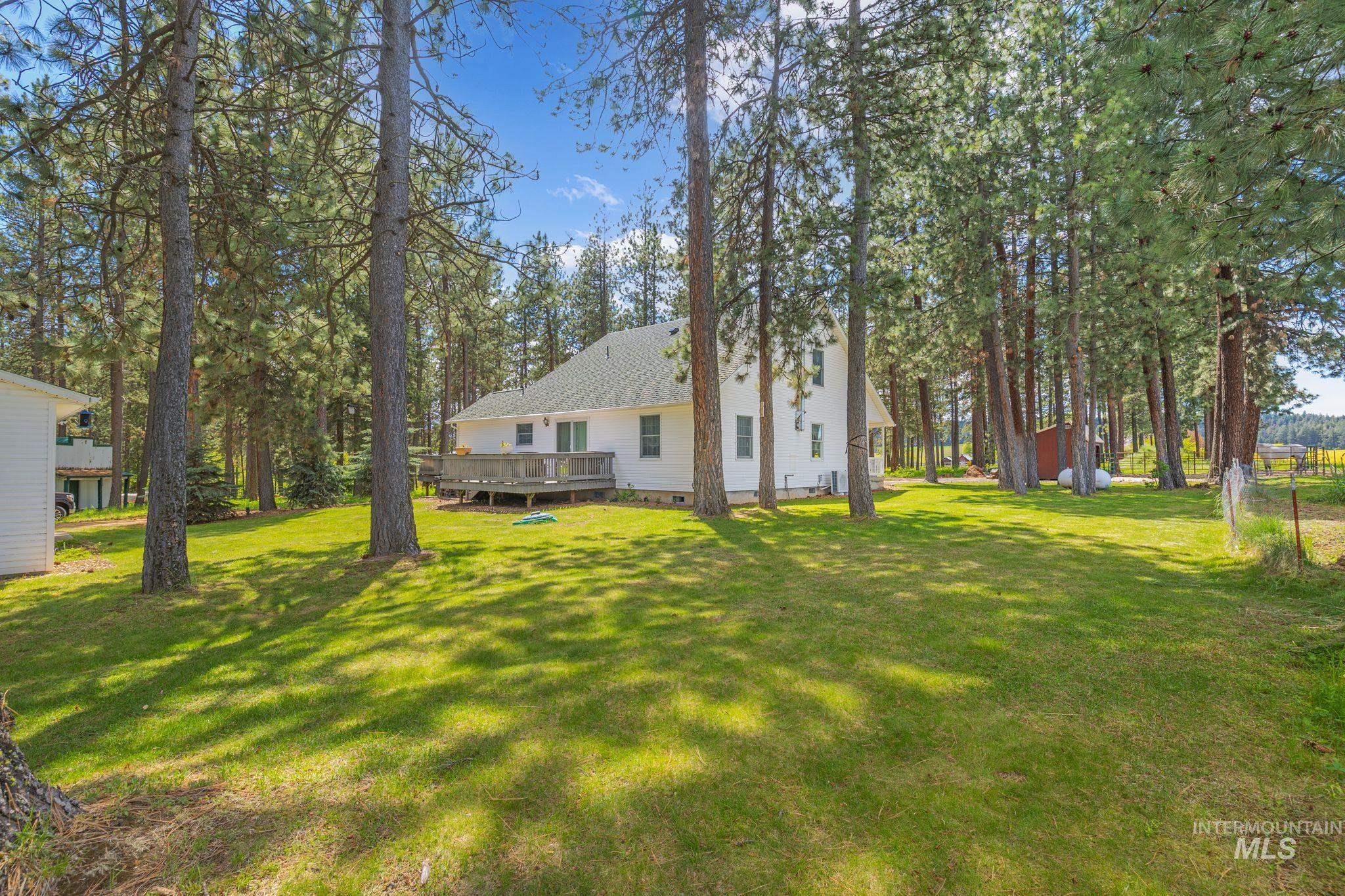 1820 Winchester Road Winchester, ID 83555 - Photo 33 of 50 Expansive lot featuring mature trees, a manicured lawn, and a spacious outdoor deck