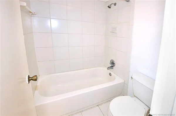 a white bath tub sitting next to a white toilet