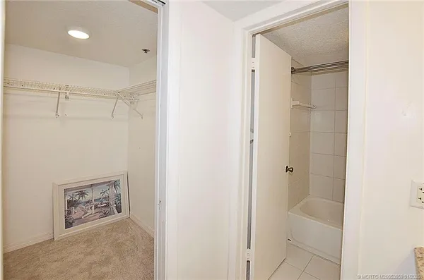 a bathroom with a shower and a glass door