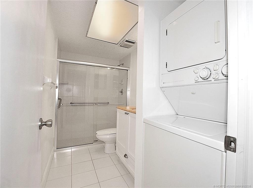 950 South Kanner Highway, Unit 9 Stuart, FL 34994 - Photo 15 of 22 a bathroom with a granite countertop toilet and a shower