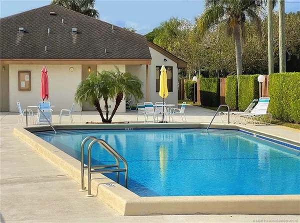 a backyard of a house with table and chairs
