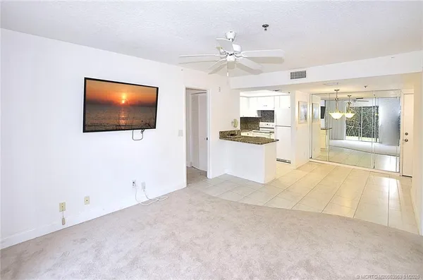 a view of a kitchen with a sink a kitchen microwave and stove