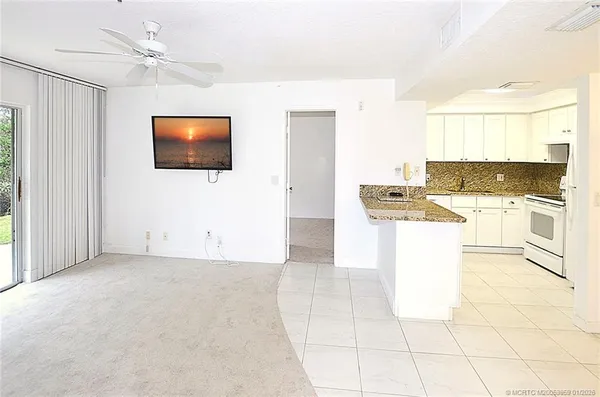 a view of a kitchen with microwave and stove top oven