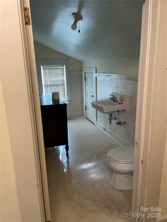 a view of a hallway and a livingroom with furniture