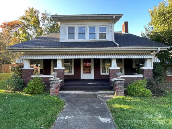 a front view of a house with a yard and porch