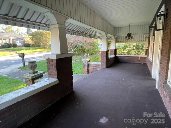 a view of a porch with furniture and a backyard