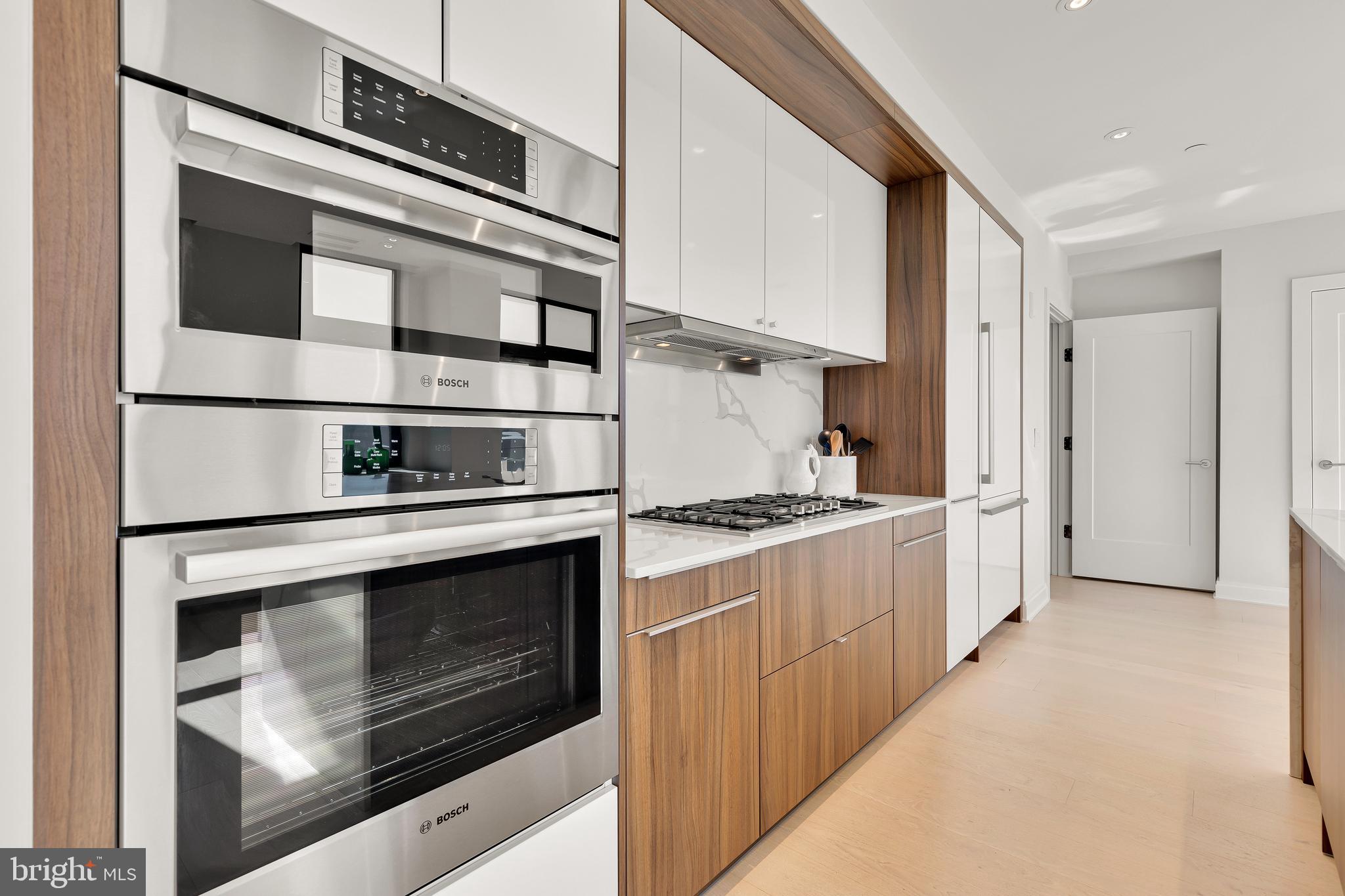 1427 Rhode Island Avenue Northwest, Unit PH01 Washington, DC 20005 - Photo 14 of 60 a kitchen with stainless steel appliances granite countertop a stove and a refrigerator