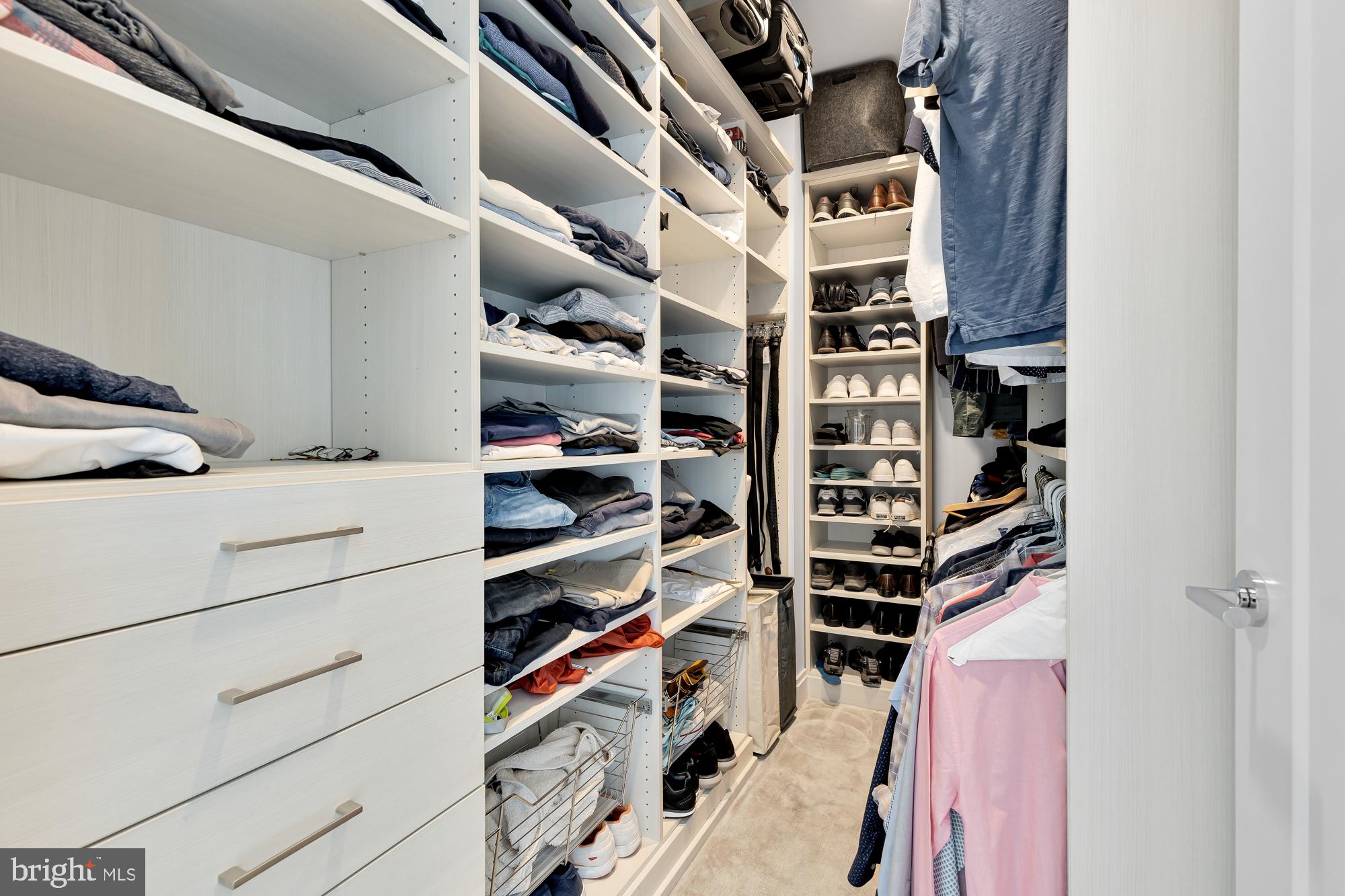 1427 Rhode Island Avenue Northwest, Unit PH01 Washington, DC 20005 - Photo 19 of 60 a view of walk in closet with clothes and shoes