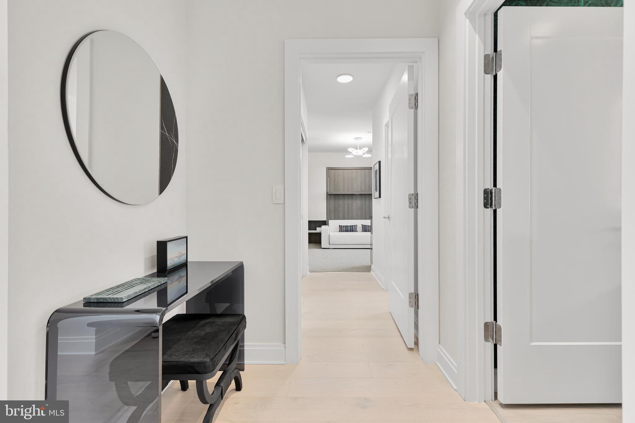 1427 Rhode Island Avenue Northwest, Unit PH01 Washington, DC 20005 - Photo 28 of 60 a view of a hallway with workspace and a mirror