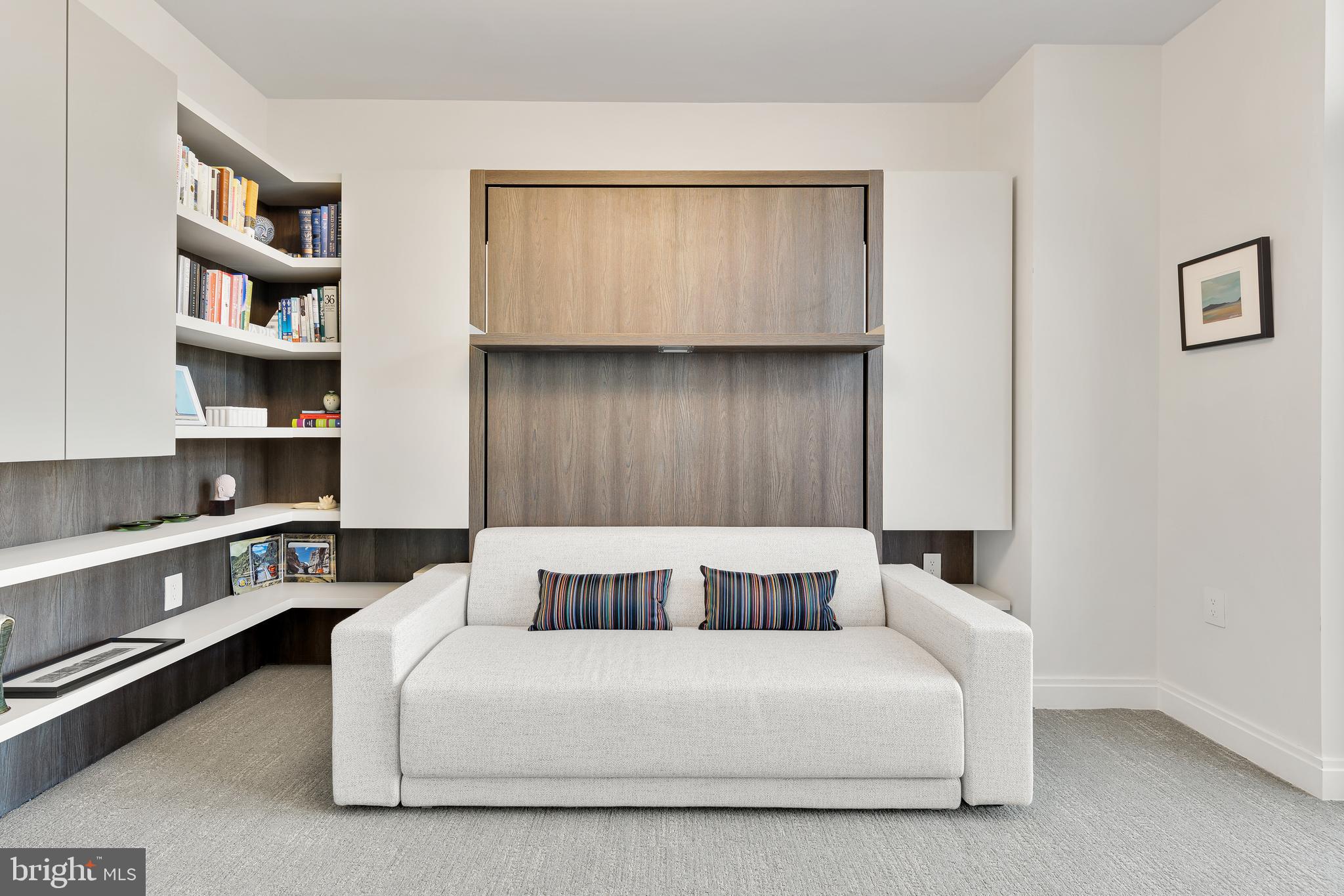 1427 Rhode Island Avenue Northwest, Unit PH01 Washington, DC 20005 - Photo 36 of 60 a living room with a bed and a book shelf