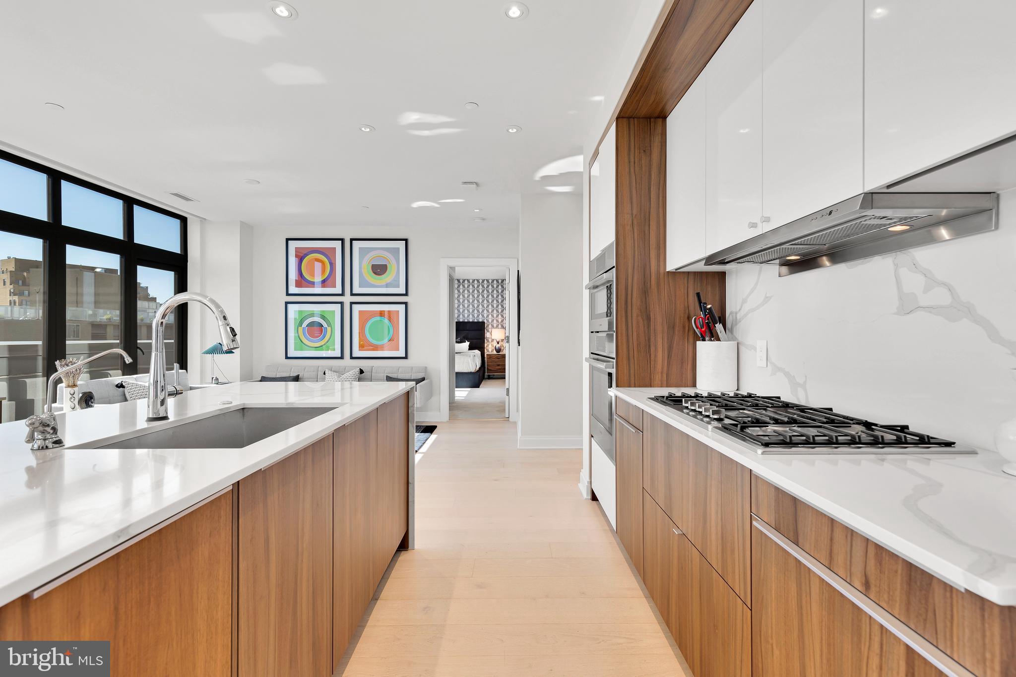 1427 Rhode Island Avenue Northwest, Unit PH01 Washington, DC 20005 - Photo 10 of 60 a kitchen with stainless steel appliances a sink and stove
