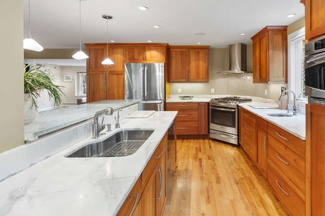 75 Cedar Street Lexington, MA 02421 - Photo 11 of 42 a kitchen with stainless steel appliances granite countertop a sink a stove and a wooden floors