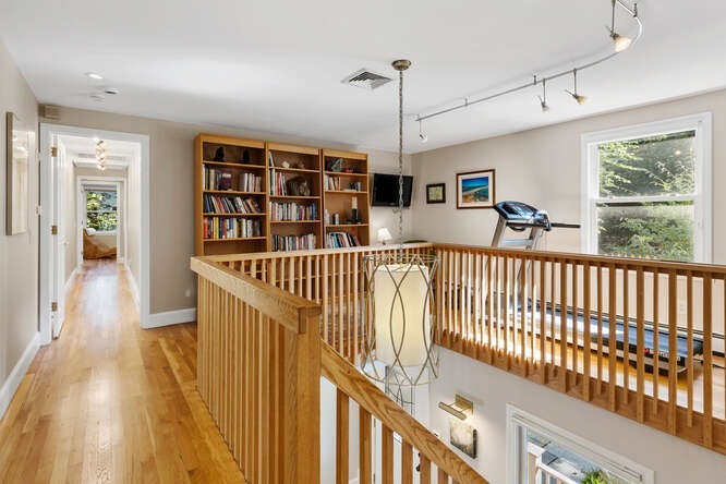 75 Cedar Street Lexington, MA 02421 - Photo 19 of 42 a view of a hallway with wooden floor and windows