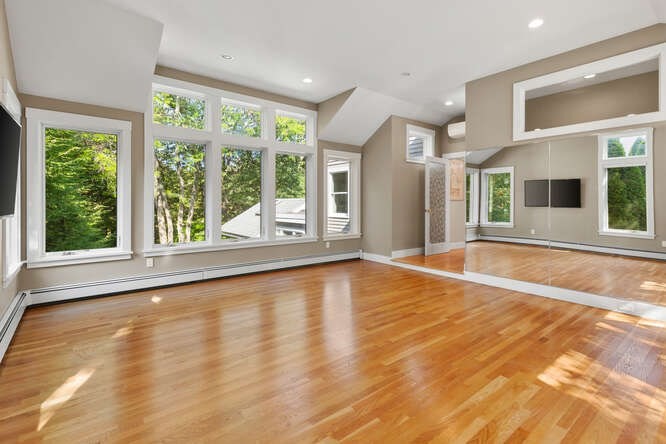 75 Cedar Street Lexington, MA 02421 - Photo 24 of 42 a view of an empty room with wooden floor and a window
