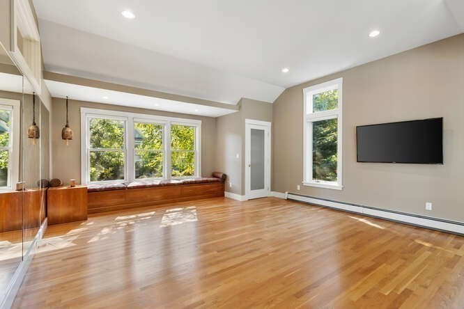 75 Cedar Street Lexington, MA 02421 - Photo 27 of 42 an empty room with wooden floor and windows
