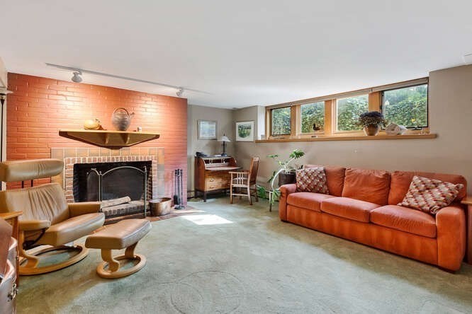 75 Cedar Street Lexington, MA 02421 - Photo 34 of 42 a living room with furniture a fireplace and a flat screen tv