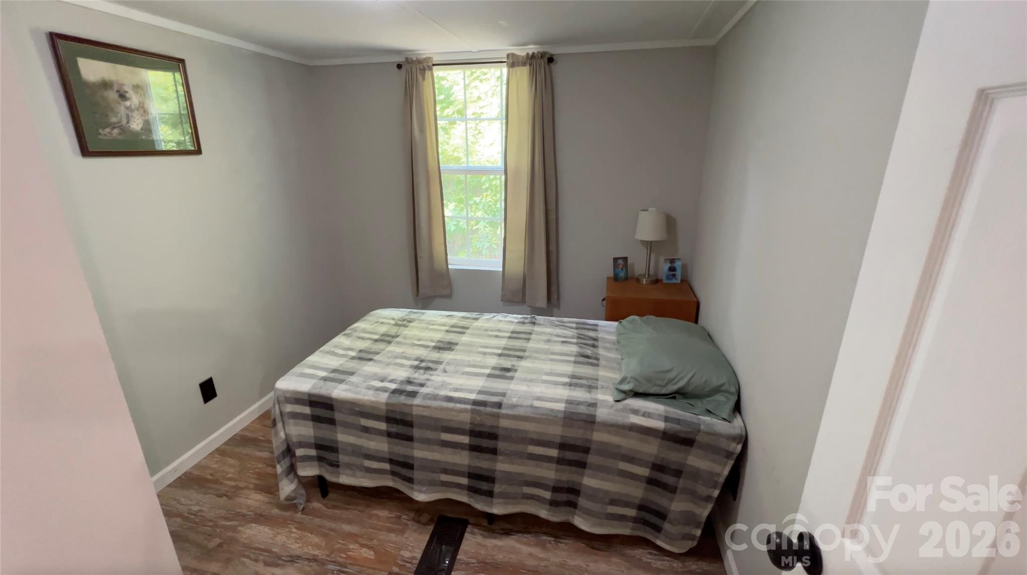 1019 Hudlin Gap Road Pisgah Forest, NC 28768 - Photo 19 of 24 a bed sitting in a bedroom next to a window
