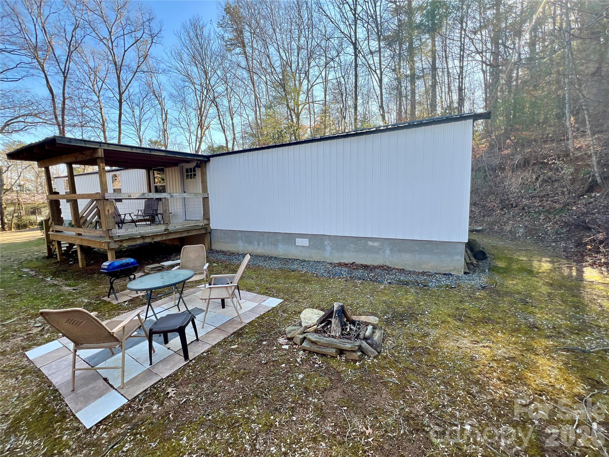 1019 Hudlin Gap Road Pisgah Forest, NC 28768 - Photo 6 of 24 a backyard of a house with yard and outdoor seating