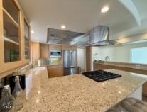 3744 Ocean Drive Oxnard, CA 93035 - Photo 11 of 15 a kitchen with stainless steel appliances granite countertop a sink a stove and a refrigerator