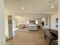 a bedroom with furniture and a mirror