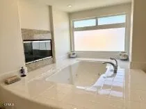 a bathroom with a bathtub and a shower