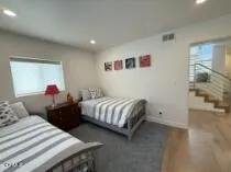 a bedroom with two beds and a closet