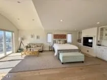 a spacious bedroom with a large bed and a tv