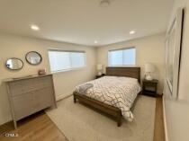 3744 Ocean Drive Oxnard, CA 93035 - Photo 8 of 15 a bedroom with a bed and a cabinets