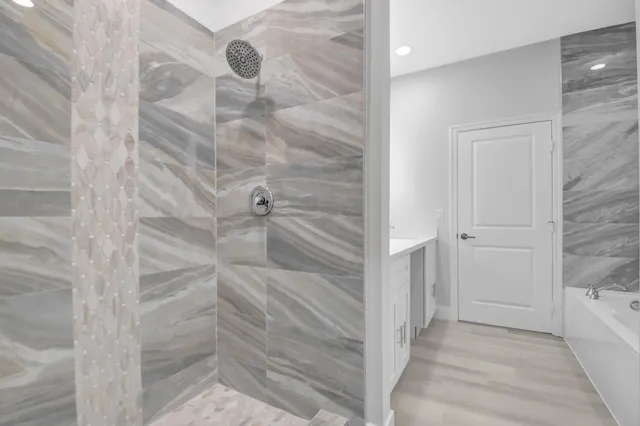 a spacious bedroom with a bed and a flat screen tv