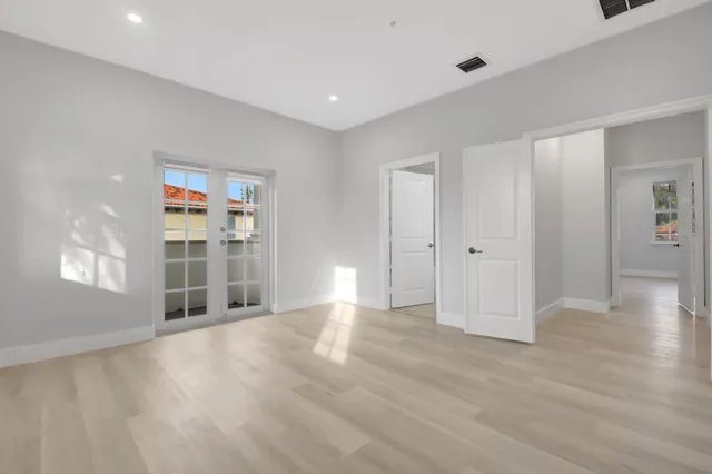 a kitchen with a refrigerator and a stove top oven